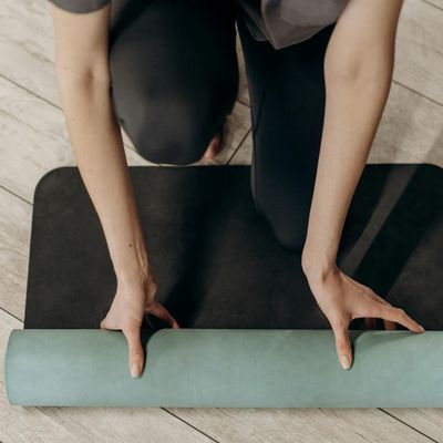 Close-up of a yoga mat corner in a sunlit room.