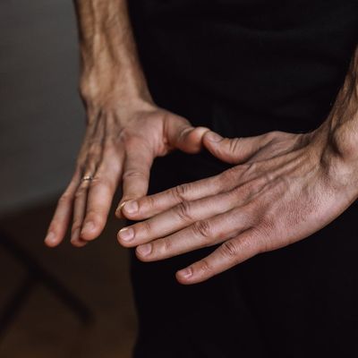 Person's hands in a meditative mudra position.